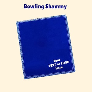 May include: Blue microfiber bowling shammy with white stitching and the text "Your TEXT or LOGO Here" printed on it.