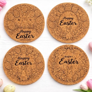 May include: Four round cork coasters with Easter-themed designs. Each coaster features a brown background with a different illustration of Easter eggs, bunnies, and floral elements. The words "Happy Easter" are written in a script font on each coaster.