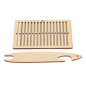 May include: A light-colored wooden rectangular weaving loom with vertical slots and a row of small holes, accompanied by a separate, elongated wooden weaving shuttle featuring a notched end and a pointed tip with a small hole at the end.