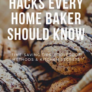 May include: A book cover with the title "Easy Baking Hacks Every Home Baker Should Know" in white text on a brown background. The subtitle is "Time-Saving Tips, Foolproof Methods & Kitchen Secrets" in white text. The author's name, "Emily Stamatakis", is in white text at the bottom of the cover. The cover features a close-up of a basket of chocolate-covered cookies.