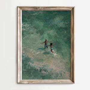Minimalist home decor mockup featuring African American beach wall art in a thin gold frame on a wood-paneled wall. This turquoise ocean oil painting of a romantic Black couple is perfect for coastal summer decor.
