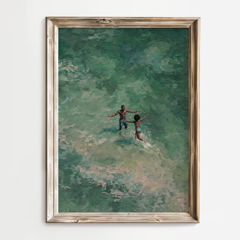 Minimalist home decor mockup featuring African American beach wall art in a thin gold frame on a wood-paneled wall. This turquoise ocean oil painting of a romantic Black couple is perfect for coastal summer decor.