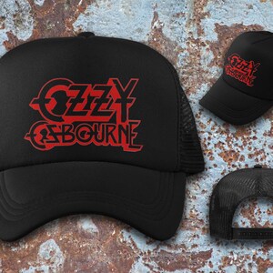 May include: Black trucker hat with a red Ozzy Osbourne logo. The logo is a stylized font with the name "Ozzy Osbourne" in red.