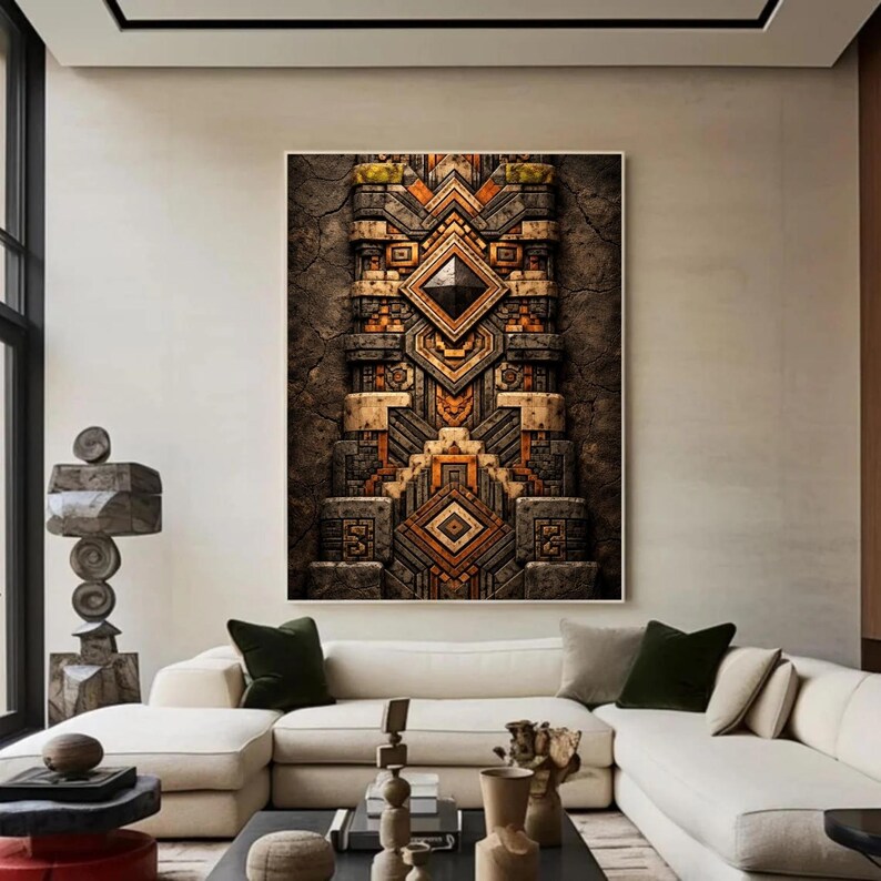 May include: A large framed artwork with an abstract geometric design in shades of brown, orange, and grey. The artwork features a central diamond shape and symmetrical patterns, creating a textured, three-dimensional effect. The piece is displayed in a modern living room setting.