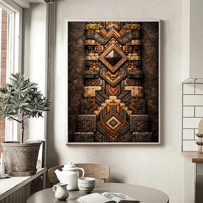 May include: Framed artwork with a detailed geometric design in brown, orange, and grey. The textured artwork features a central diamond shape and layered patterns, reminiscent of ancient architecture.