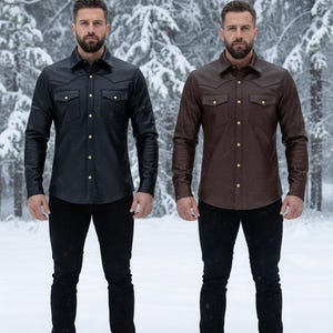 May include: Two long-sleeved leather shirts, one black and one brown, with gold-coloured buttons and chest pockets. The shirts are paired with black trousers. The background is a snowy forest.