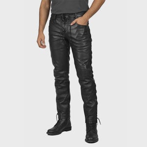 May include: Black leather trousers featuring lace-up detailing on the front and sides. The trousers have a fitted design and are worn with black boots. The model is wearing a grey t-shirt.