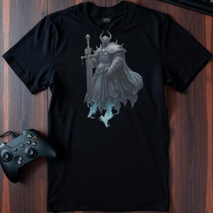 May include: Black t-shirt with a graphic print of a knight in armor holding a sword. The knight is standing on a cloud of smoke.