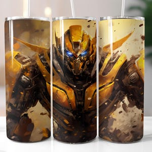 Puede incluir: Tres vasos de acero inoxidable con una ilustración de Bumblebee. La obra de arte muestra al personaje de Transformers en amarillo, negro y marrón, con ojos azules, sobre un fondo texturizado.