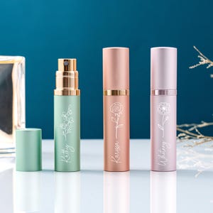 May include: Three pastel-coloured perfume atomisers. The green one has a floral design and the name "Kathy". The pink one has a rose design and the name "Karissa". The lavender one has a floral design and the name "Whitney".