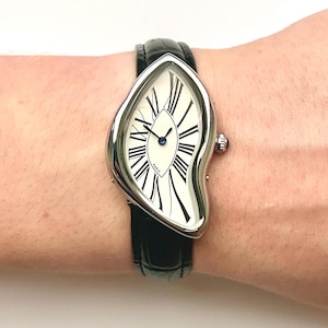 Reloj vintage de plata y oro, diseño surrealista, esfera distorsionada, elegante correa de cuero negro, reloj de pulsera Dali clásico retro con efecto desvanecido.