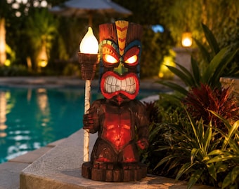May include: A brown tiki statue with a fierce expression, glowing red eyes, and a yellow-tipped flame design on its forehead. The figure holds a tall torch with a bright, white, flame-shaped light bulb at the top, illuminating the dark brown surface.