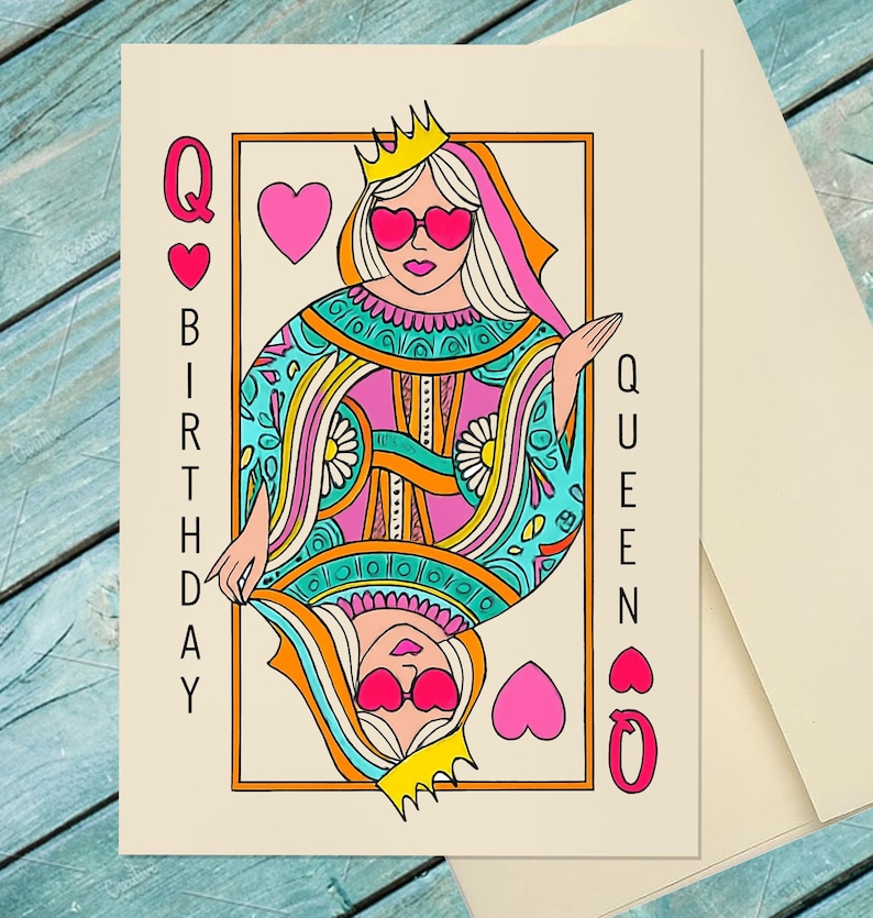 May include: A birthday card featuring a colorful illustration of a queen playing card. The queen wears a crown and heart-shaped sunglasses. The card has the words "Q BIRTHDAY QUEEN Q" on it, with hearts as accents. The card is on a cream-colored background.