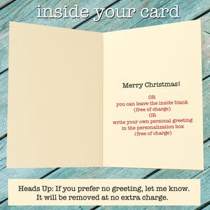 May include: An open greeting card with a cream-colored interior. The right side features black text reading Merry Christmas, followed by red text explaining options to leave the inside blank or add a personal greeting. A note below reads Heads Up.