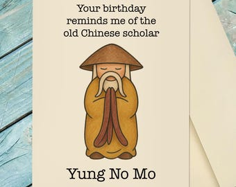 May include: A birthday greeting card with a cartoon illustration of an old Chinese scholar in a brown hat and yellow robe. The text reads, "Your birthday reminds me of the old Chinese scholar" and "Yung No Mo."