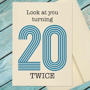 May include: A birthday greeting card with the text "Look at you turning 20 TWICE". The number 20 is in blue with a striped design. The card is cream-colored and comes with a matching envelope.