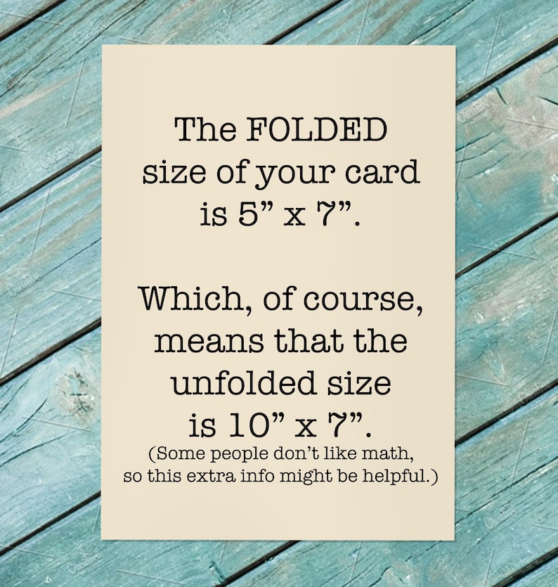 May include: A cream-colored card with black text. The text states the folded size is 5" x 7" and the unfolded size is 10" x 7". The card is on a teal, weathered wood surface.