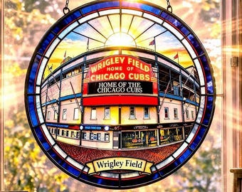 May include: A stained glass window depicting Wrigley Field, home of the Chicago Cubs, hangs in front of a bright window. A baseball bat, baseball, and Cubs memorabilia are on display. A baseball cap and a mug with the Cubs logo are also visible.