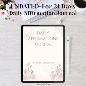 May include: An undated daily affirmation journal on a tablet. The journal's cover displays "DAILY AFFIRMATIONS JOURNAL" in reddish-brown, with floral decorations. A stylus and earbuds are also visible. The text "THIS JOURNAL BELONGS TO" is also present.