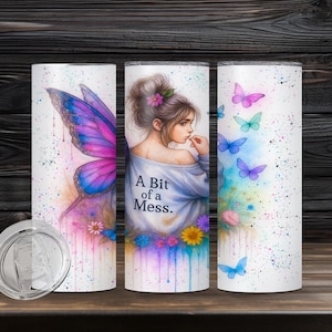 May include: A set of three white stainless steel tumblers with butterfly and floral designs. One tumbler features a large butterfly wing, another has a woman with the text "A Bit of a Mess", and the third has butterflies.