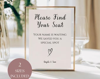 May include: A framed sign with the text "Please Find Your Seat" in elegant script. Below, it reads "Your name is waiting, we saved you a special spot" with a heart symbol and names "Angela & Sam". A circular label indicates "2 Sizes Included".
