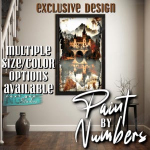 May include: A framed print of a castle reflected in water, with mountains in the background. The artwork has a watercolor effect with warm tones. Text on the print reads "EXCLUSIVE DESIGN" and "Paint by Numbers". Additional text states "MULTIPLE SIZE/COLOR OPTIONS AVAILABLE".