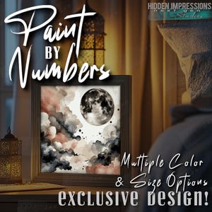 Puede incluir: Kit de pintura por números con una pintura de acuarela de una luna llena en un cielo nublado con tonos de rosa, gris y negro. El texto "Paint by Numbers" está en letras grandes y estilizadas sobre la imagen. El texto "Multiple Color & Size Options" y "Exclusive Design!" está debajo de la imagen.