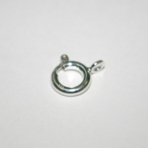 May include: Silver-toned metal clasp with a round ring and a small loop. The clasp is marked with "925" indicating sterling silver.