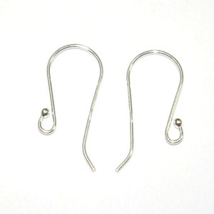 May include: Two silver earring hooks with a small ball at the end of each hook.