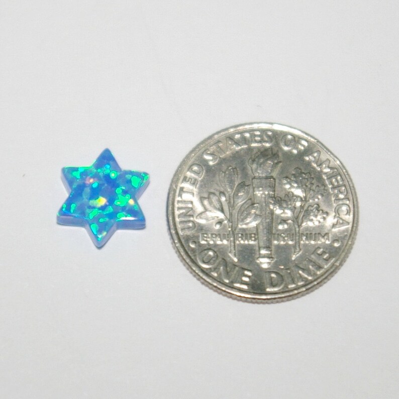 May include: A blue opal star of David pendant, approximately the size of a US dime.