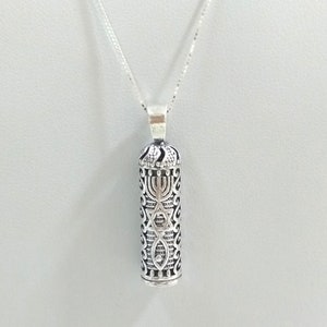 May include: A silver necklace with a pendant shaped like a scroll. The pendant is decorated with a menorah, a Star of David, and a fish.