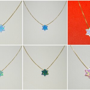 May include: Six gold necklaces with a six-pointed star pendant made of iridescent opal. The necklaces are displayed on a white background. The opals are in various colors, including blue, green, pink, and white.
