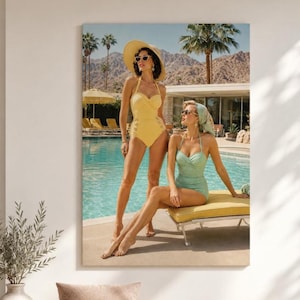 May include: A wall art print depicting two individuals by a swimming pool. One stands wearing a yellow swimsuit, a wide-brimmed straw hat, and sunglasses. The other sits on a yellow lounge chair wearing a light green swimsuit and headscarf.