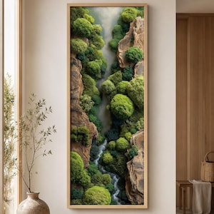 May include: A vertical rectangular wall art piece featuring a high-angle view of a narrow river flowing through a rocky canyon. The landscape is densely covered in vibrant green moss and rounded shrubbery, contrasting with the textured brown rock faces.