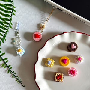 May include: A white ceramic mug with a black handle and the text "But First, Coffee" in a handwritten style. The mug is on a white surface. The mug is approximately 4 inches tall.