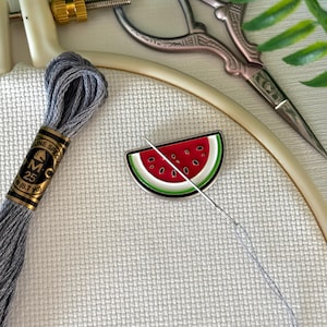 May include: A set of three ceramic mugs with a speckled, matte finish. The mugs are in shades of cream, light gray, and dark gray. Each mug has a simple, minimalist design, perfect for coffee or tea.