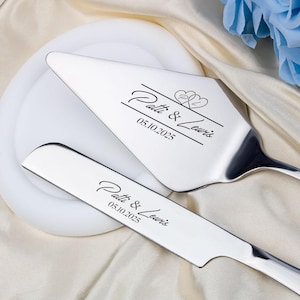 May include: A set of two silver cake servers with black engraved text. The text reads "Patti & Lewis" and "05.10.2025".