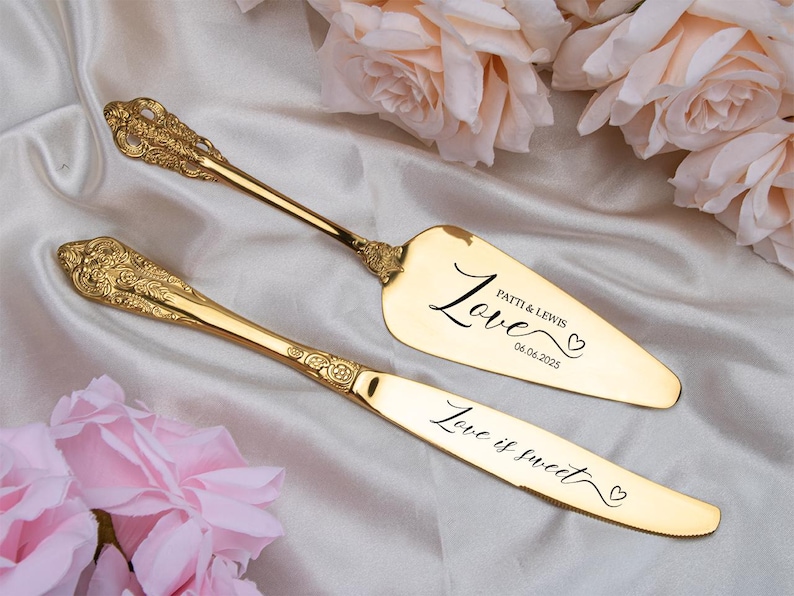 May include: Gold-colored cake server and knife set with ornate handles. The server has the word "Love" and the names "Patti & Lewis" with a date. The knife has the phrase "Love is sweet". Perfect for weddings.