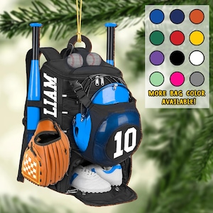 May include: A black baseball backpack ornament with blue accents, featuring a helmet, baseball bat, glove, and shoes. The backpack has the name "LIAM" in white and the number "10". Includes a color chart with the text "MORE BAG COLOR AVAILABLE!"