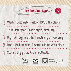 May include: A white fabric care label with red text and a red button. The label reads "Care Instructions" and provides washing, drying, ironing, and storage instructions, including temperature guidelines and symbols.