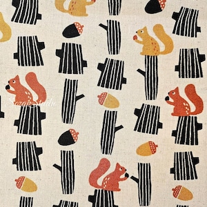 May include: A repeating pattern on a cream-colored fabric featuring stylized squirrels, acorns, and tree trunks. The squirrels are orange and yellow, the acorns are black and yellow, and the tree trunks are black and white.