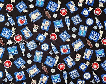 May include: Black fabric with a repeating pattern of Japanese lucky cats, sake bottles, and other traditional motifs in blue, red, and white. The design includes various rectangular and circular shapes.
