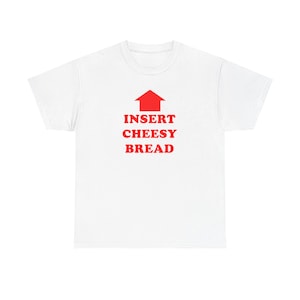 May include: White t-shirt featuring the red text "INSERT CHEESY BREAD" with a red arrow above. A simple, casual top, ideal for everyday wear. The design is printed on the front.