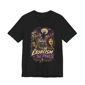 May include: A black short-sleeve t-shirt featuring a graphic print titled The Exorcism of the Pines. The design includes a winged demon, a house, a priest holding a cross, and a woman's face, with text reading Not all evil comes from a soul.