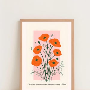 May include: A framed print with a pink background and a bouquet of orange poppy flowers. The quote "Out of your vulnerabilities will come your strength." - Freud is printed below the flowers.