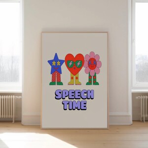 May include: A framed art print featuring three cartoon characters: a blue star, a red heart, and a pink flower. Each character has sunglasses and patterned legs. The text "SPEECH TIME" is below the characters in purple and white.