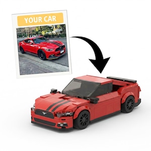May include: A red toy car made of interlocking blocks, with black racing stripes and black wheels. The toy car is a replica of a red sports car in a photo that says "YOUR CAR". The toy car has a black windshield and a spoiler.