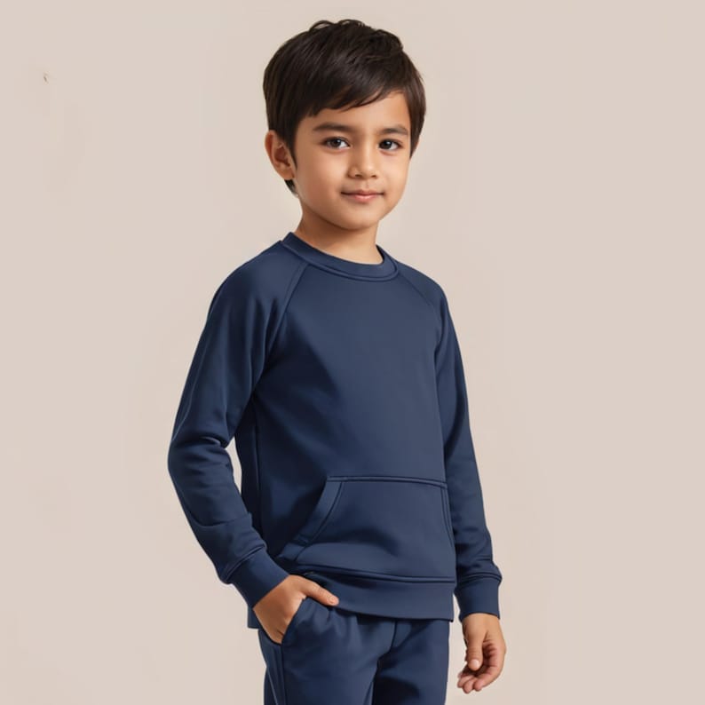 May include: A navy blue long-sleeved sweatshirt with a front pocket. The sweatshirt has a crew neck and raglan sleeves.