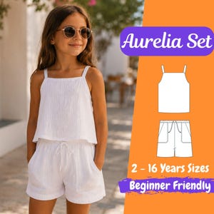 Puede incluir: Una persona joven que lleva un conjunto Aurelia blanco, compuesto por un top y unos pantalones cortos a juego. El top tiene tirantes finos y los pantalones cortos tienen bolsillos y un cordón. La imagen también muestra un diagrama del conjunto y el texto "2 - 16 Years Sizes Beginner Friendly."