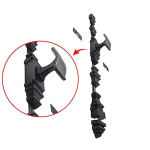 May include: A black, decorative gate latch with a detailed, ornate design. The latch features a curved handle and is accompanied by small, rectangular mounting plates. The design is highlighted with a close-up view in a red circle.